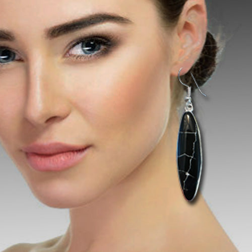 Black dangle silver earrings.